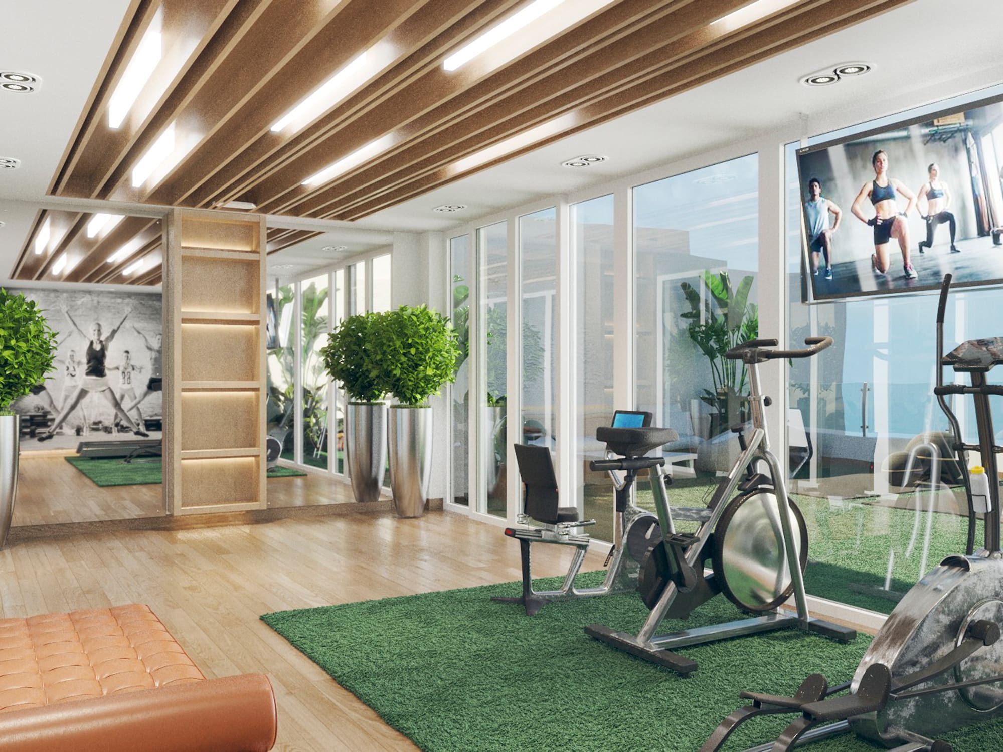 a room with exercise bikes and a tv