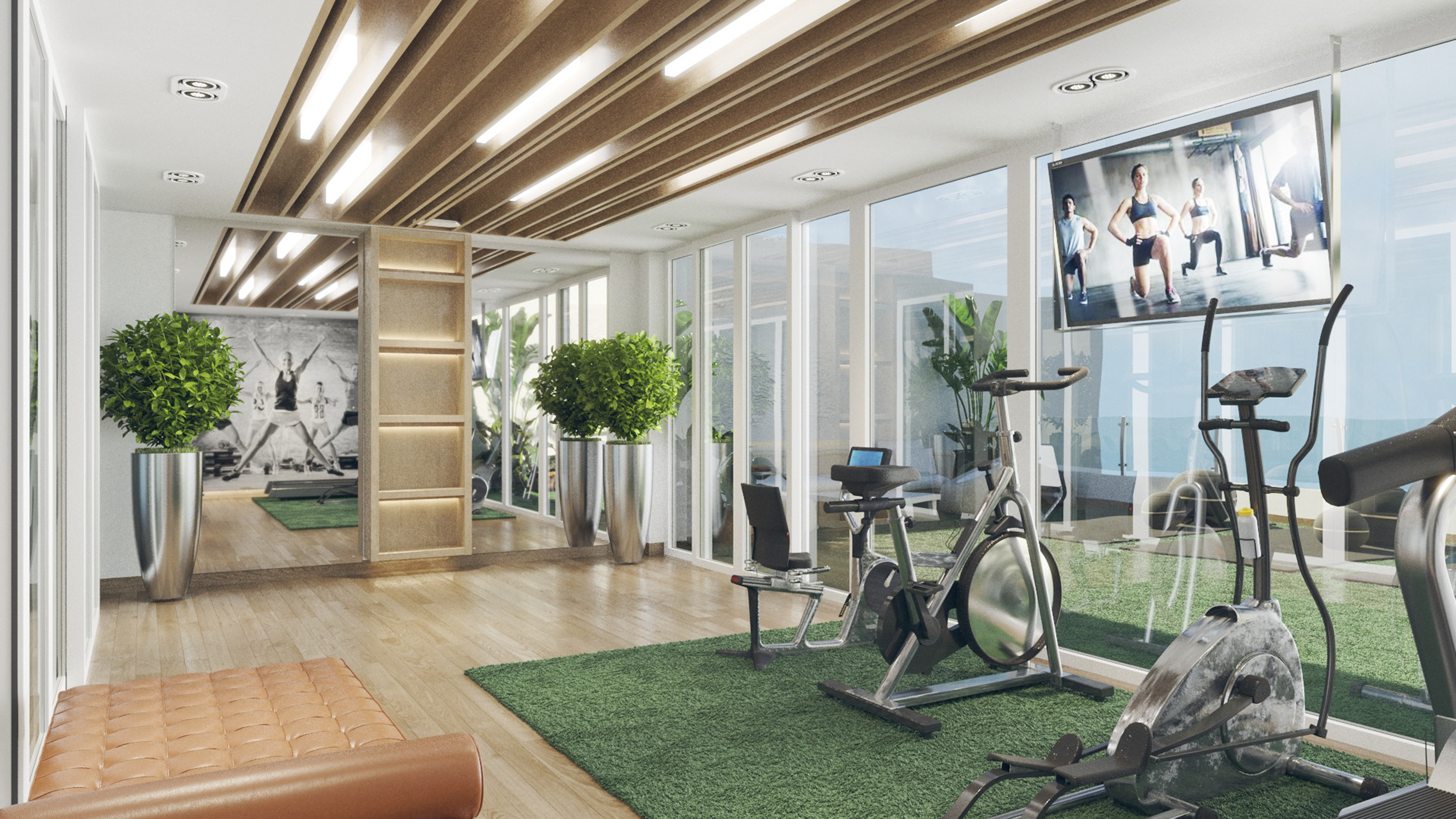 a room with exercise bikes and a tv