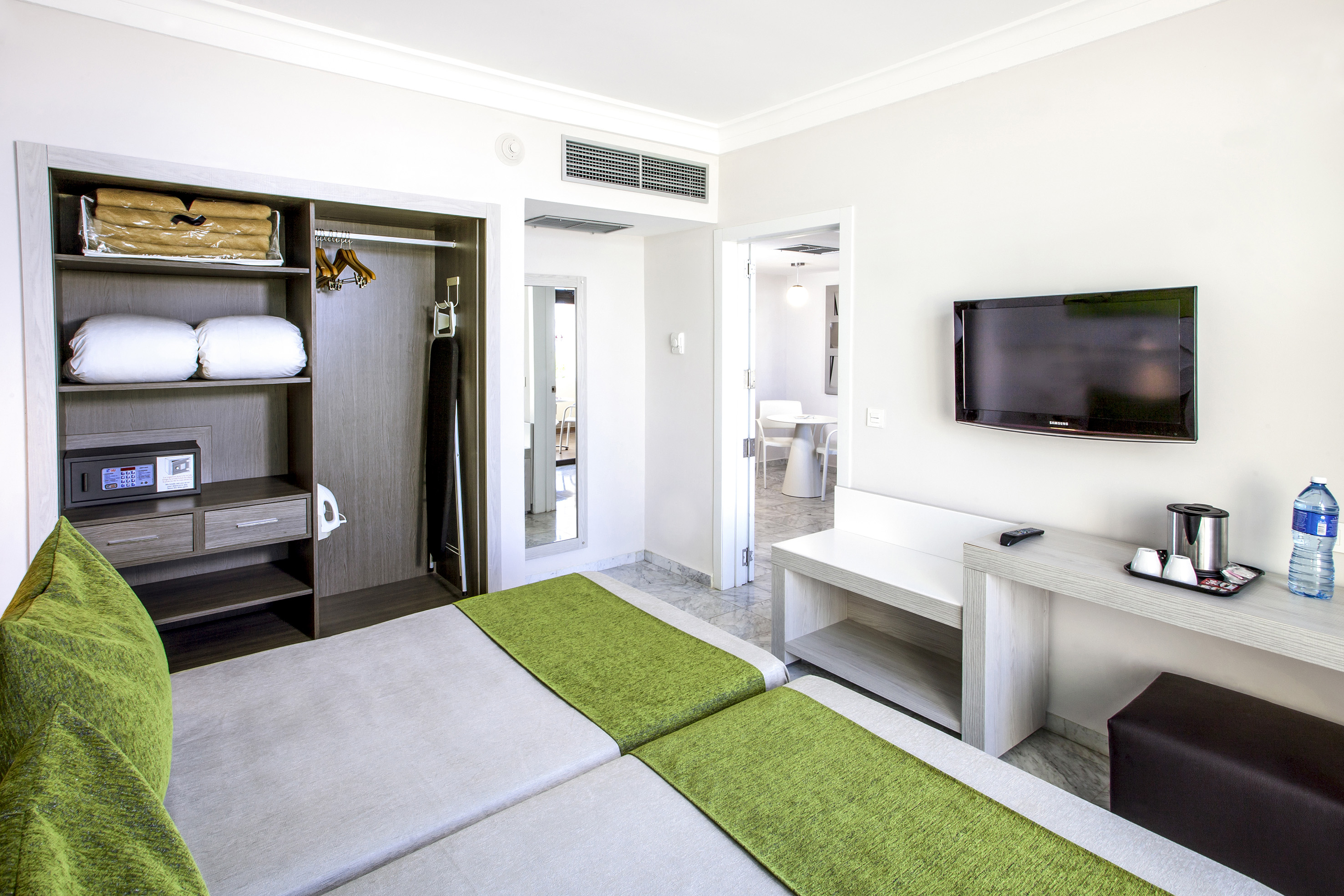 a room with a tv and a bed