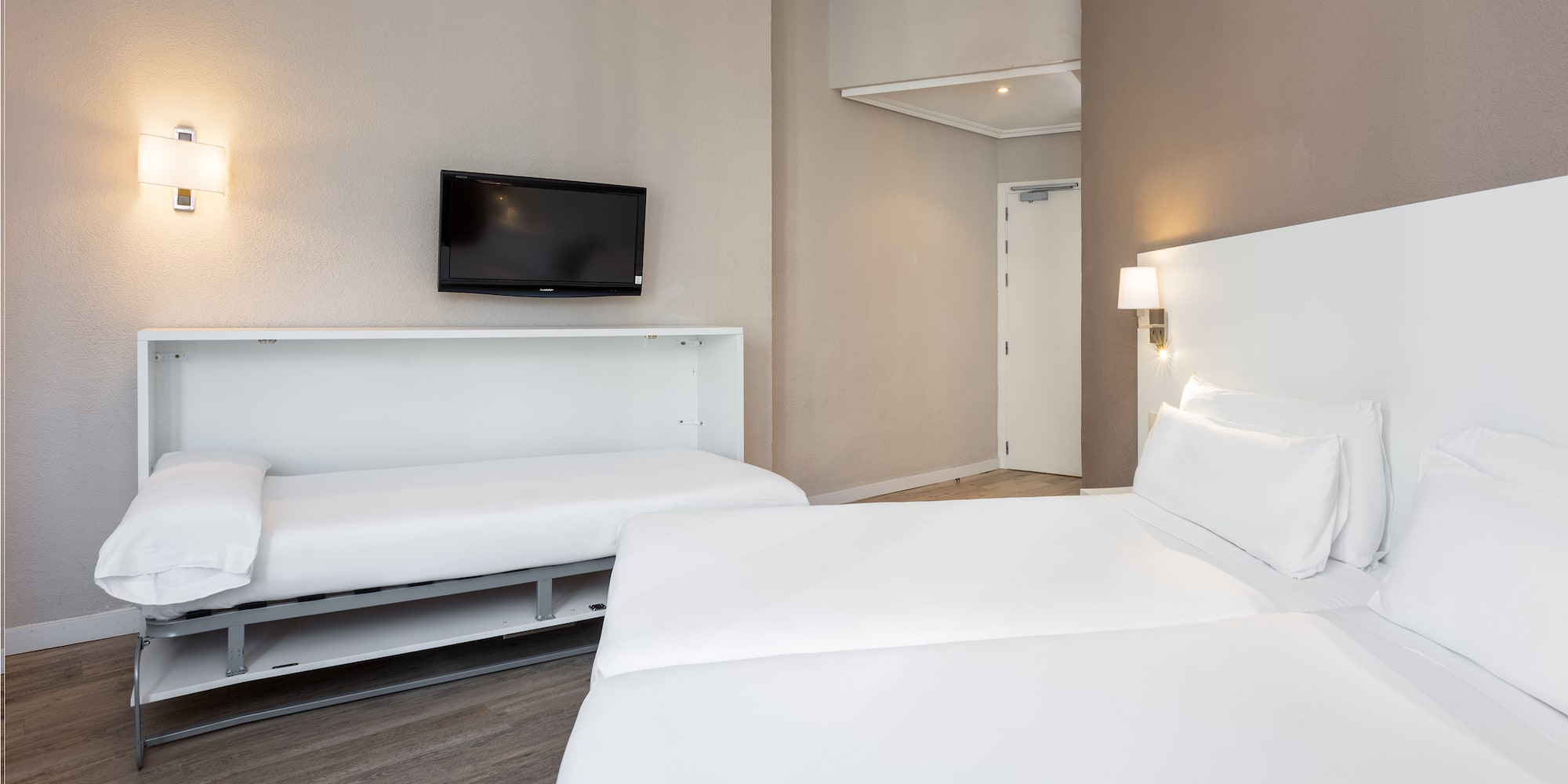 a room with two beds and a tv
