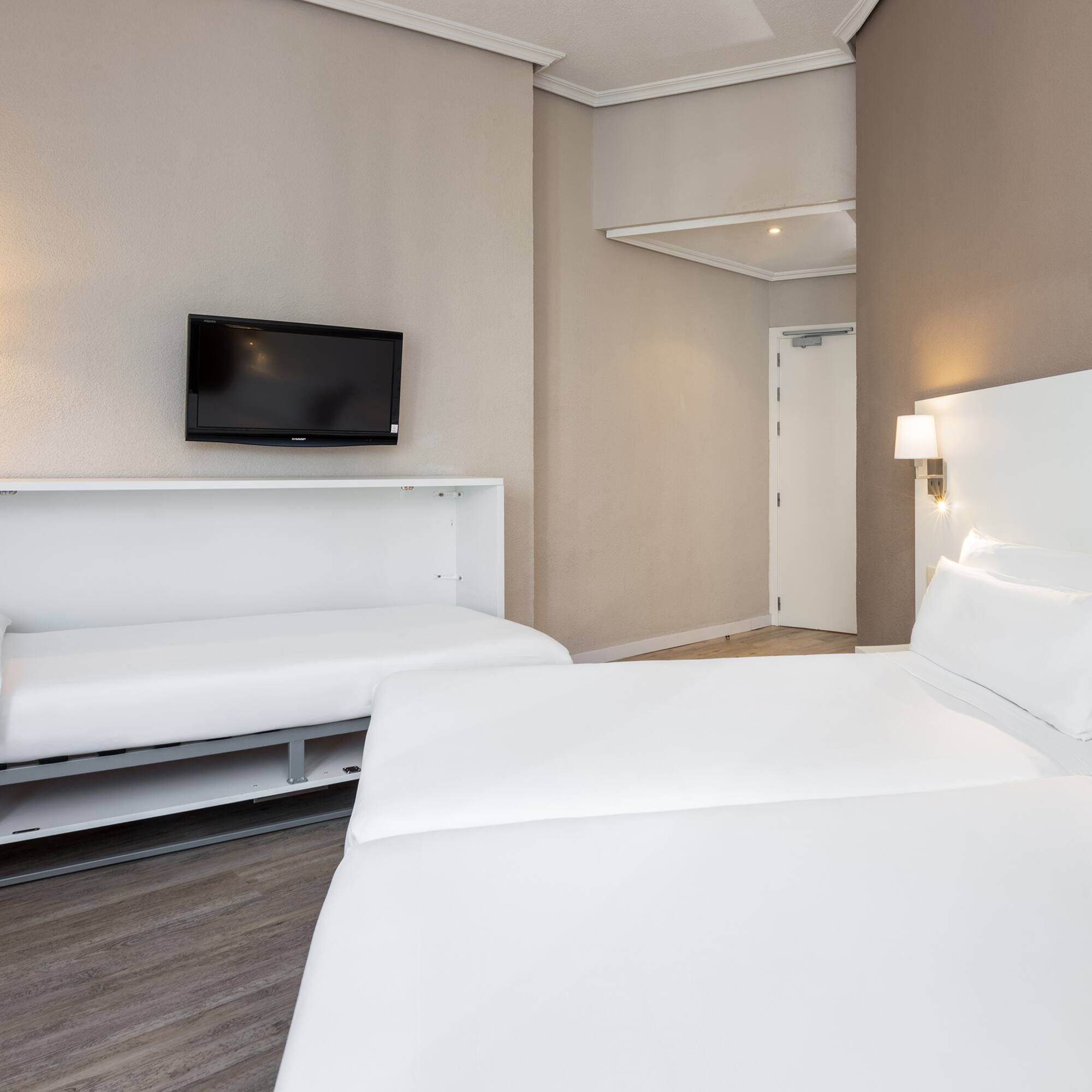 a room with two beds and a tv