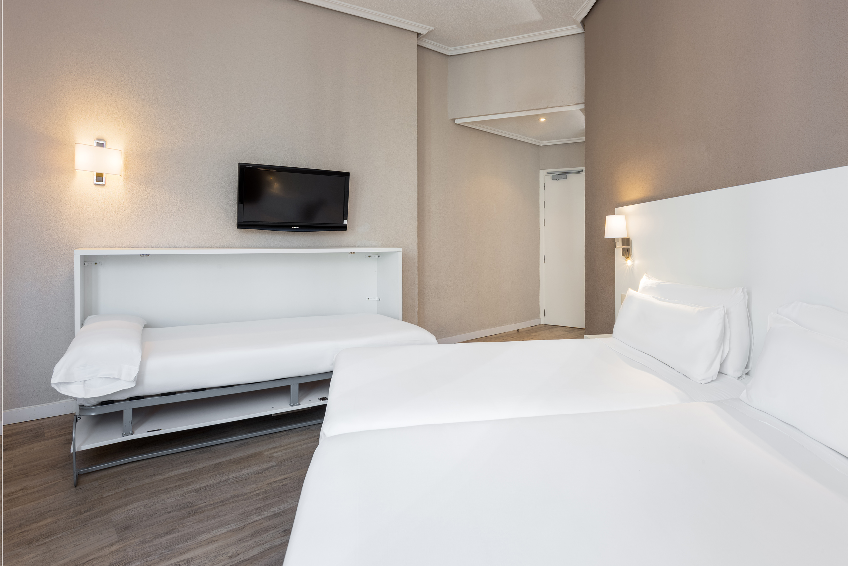 a room with two beds and a tv