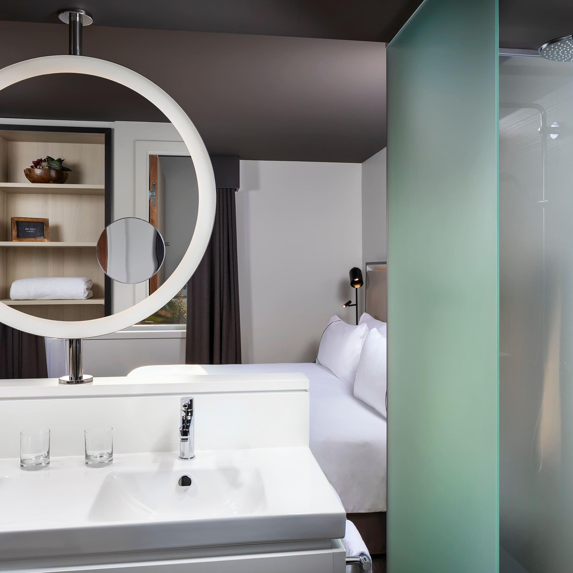 a bathroom with a mirror and a bed