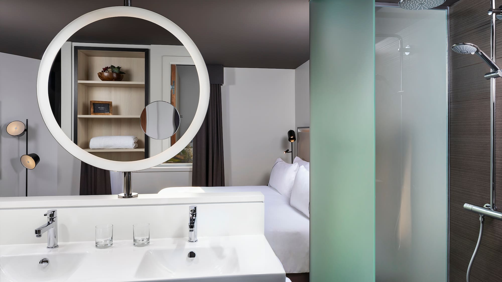 a bathroom with a mirror and a bed