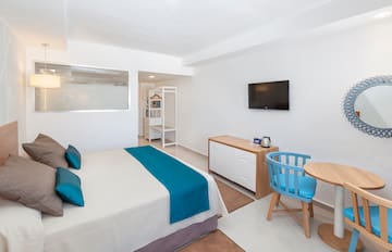 a room with a bed and a tv