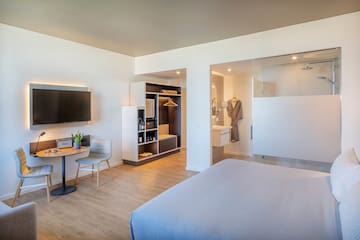 a room with a bed and a tv