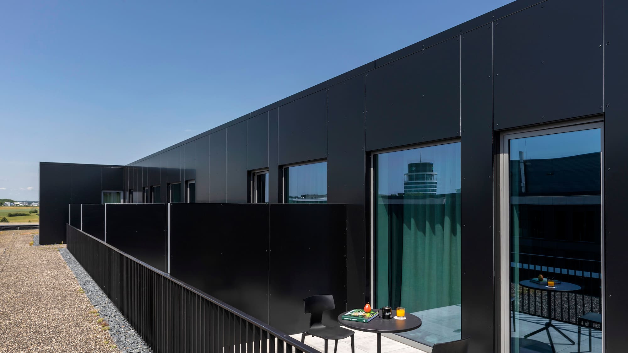 a black building with a table and chairs