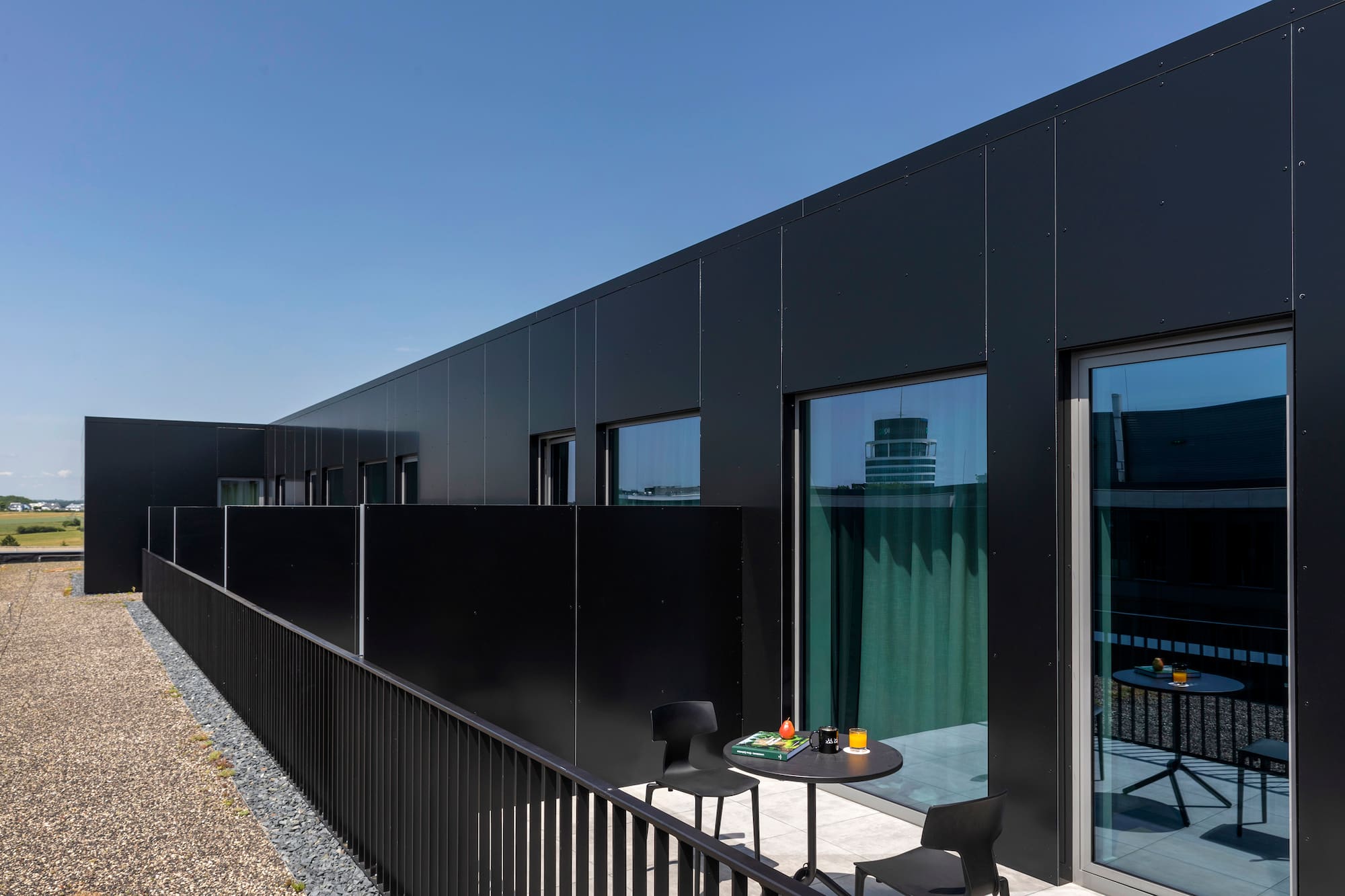 a black building with a table and chairs
