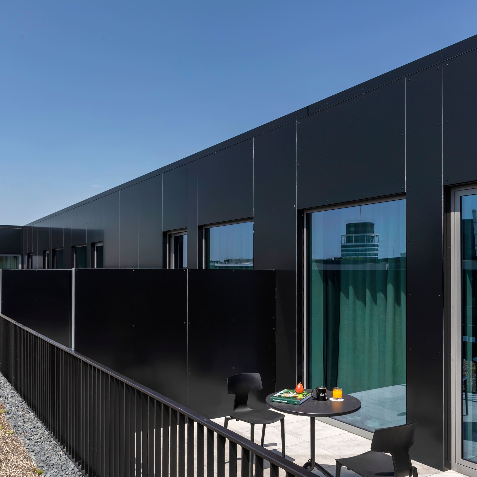 a black building with a table and chairs