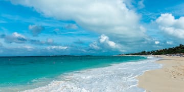 a beach with waves crashing on the shore
