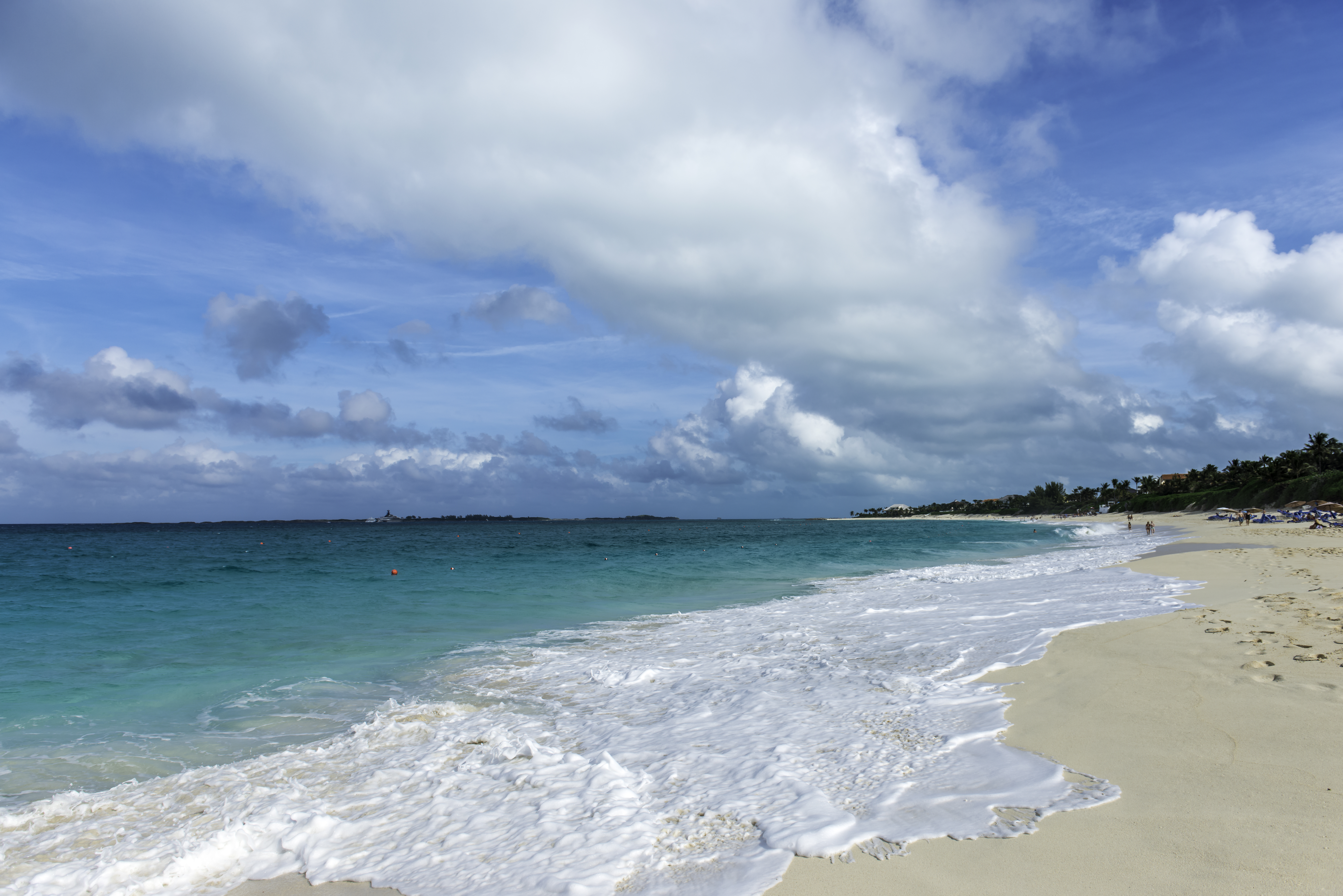a beach with waves crashing on the shore