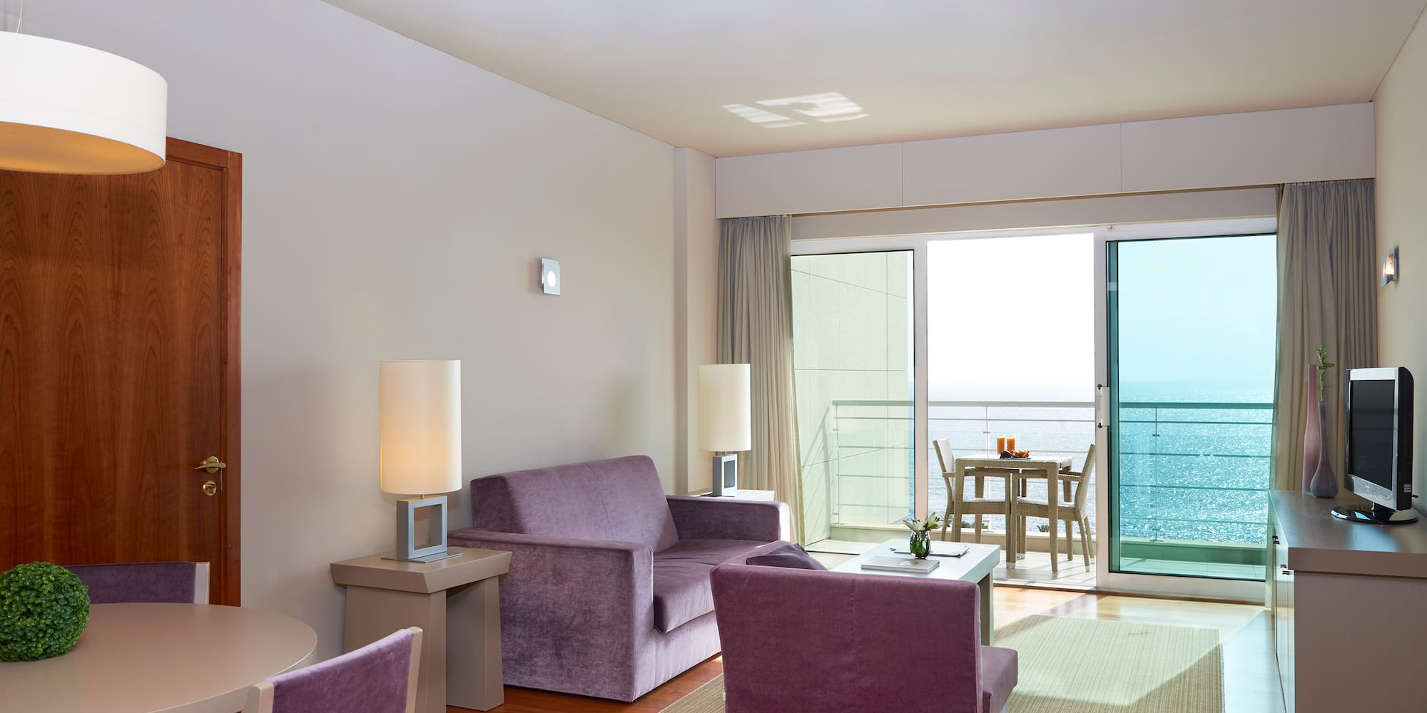 a living room with purple furniture and a table