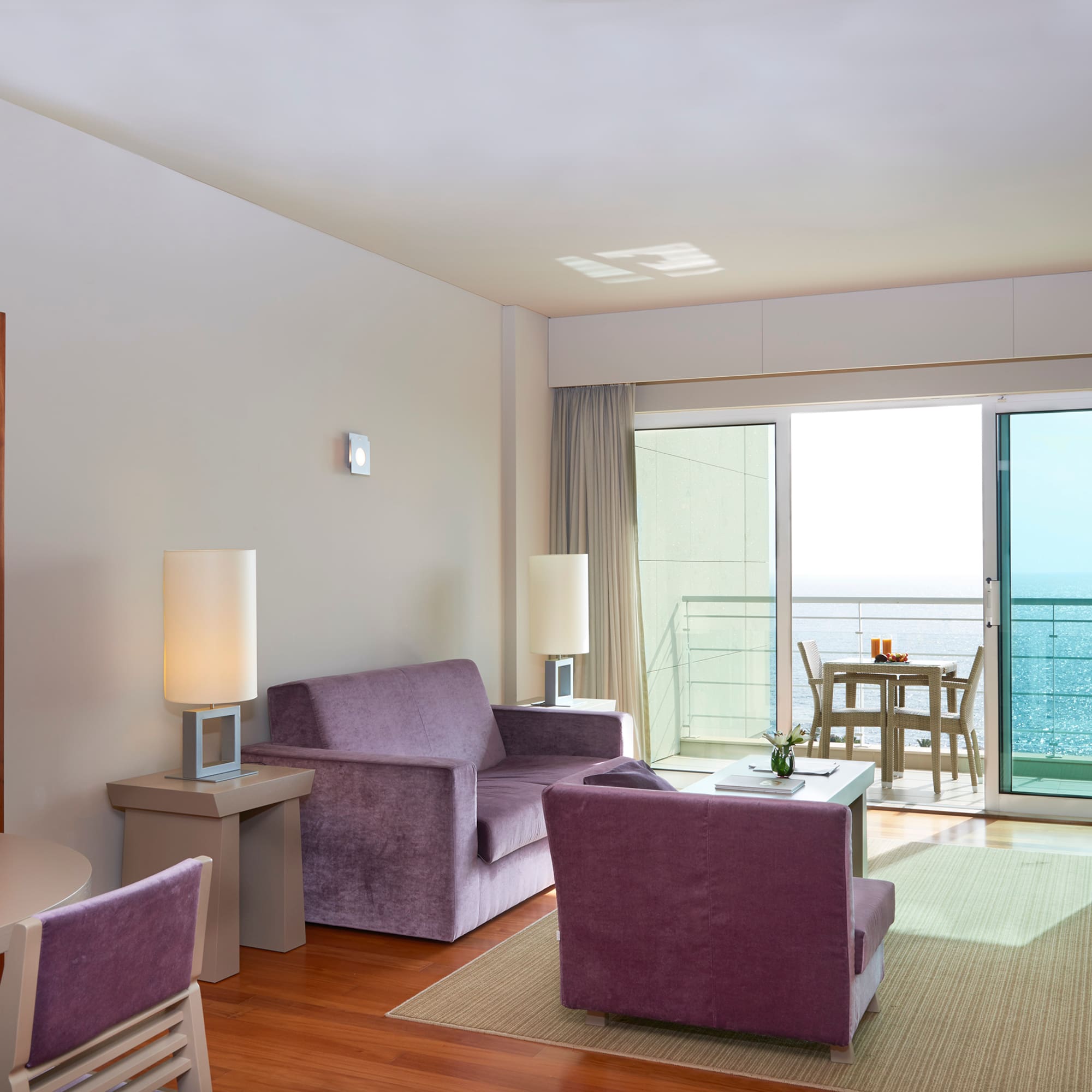 a living room with purple furniture and a table