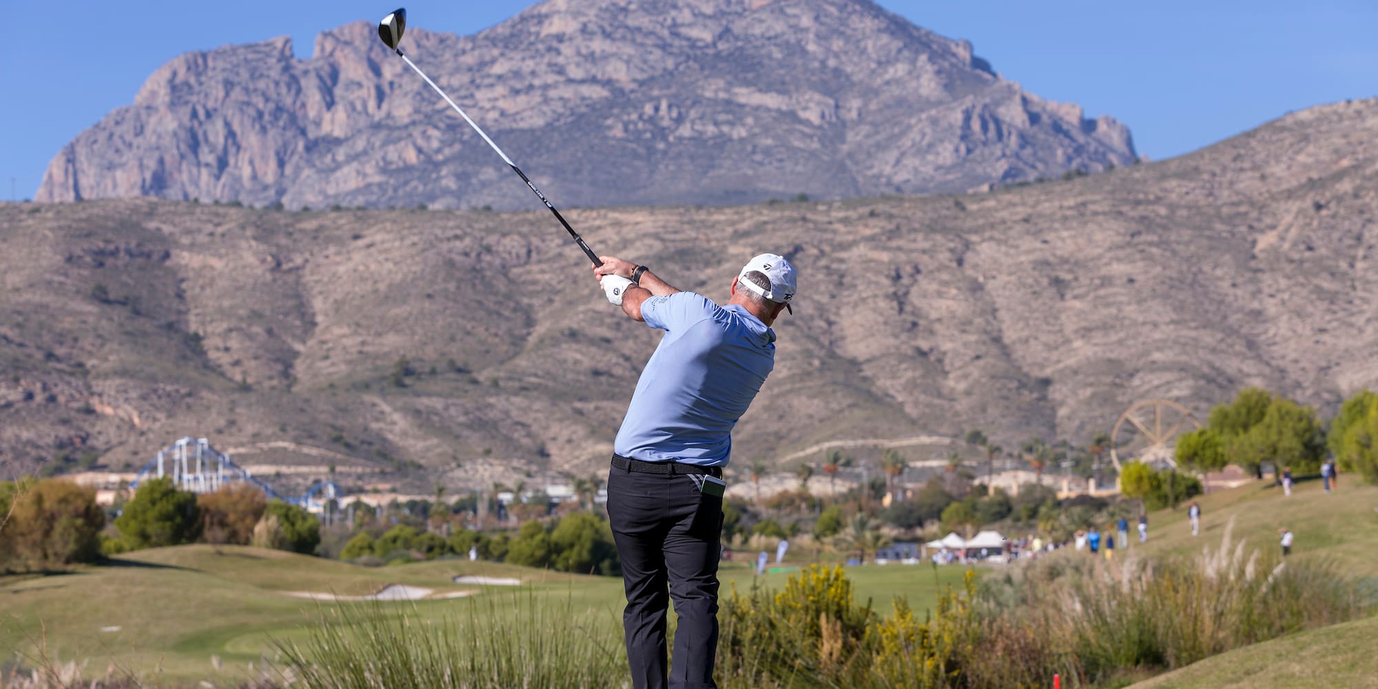 a man swinging a golf club