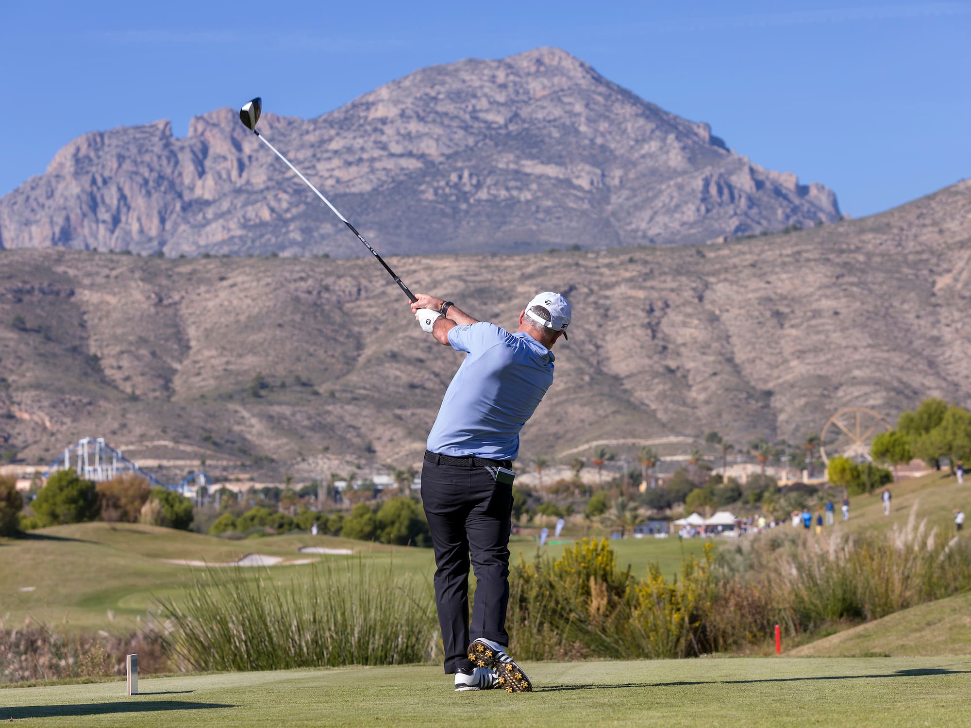 a man swinging a golf club