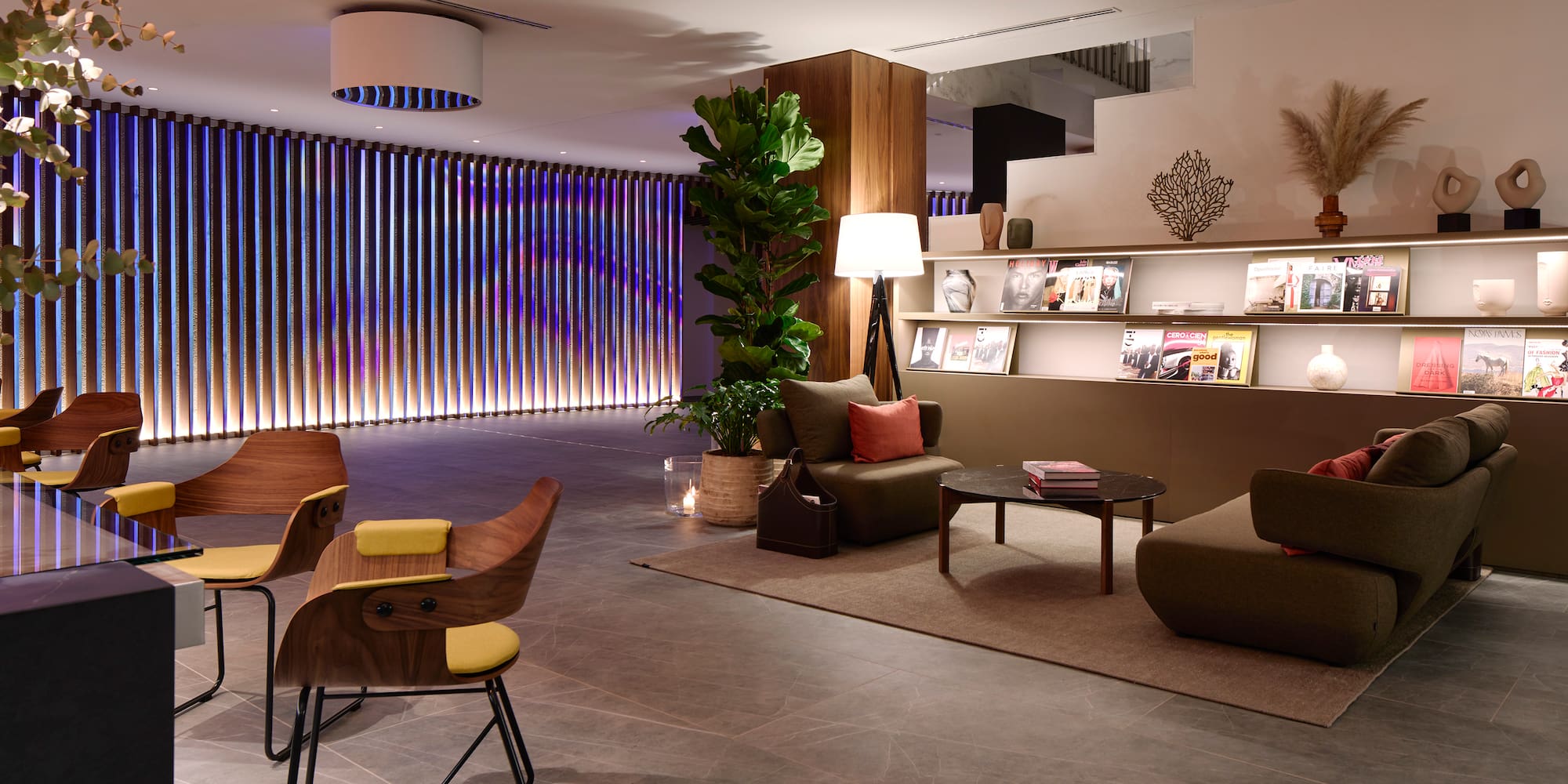 a room with a couch and chairs