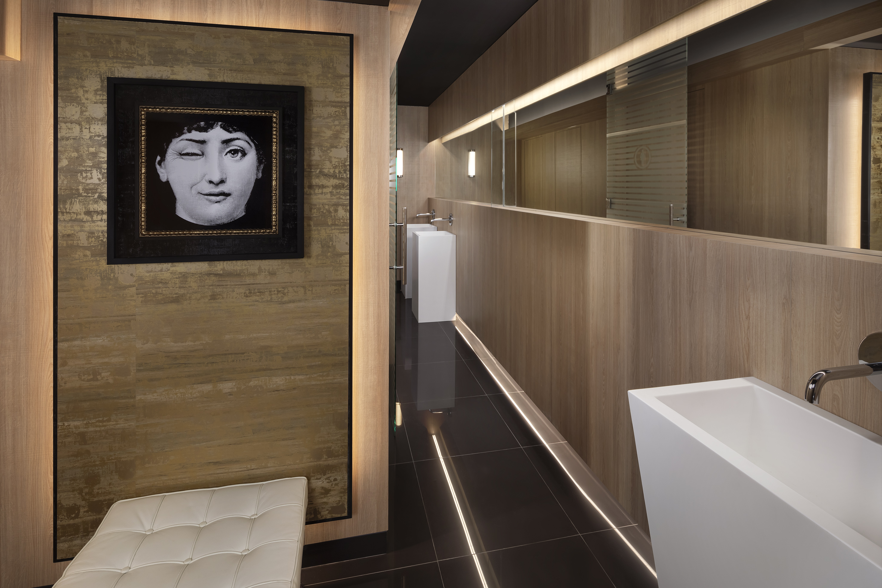 a bathroom with a black and white picture of a woman's face