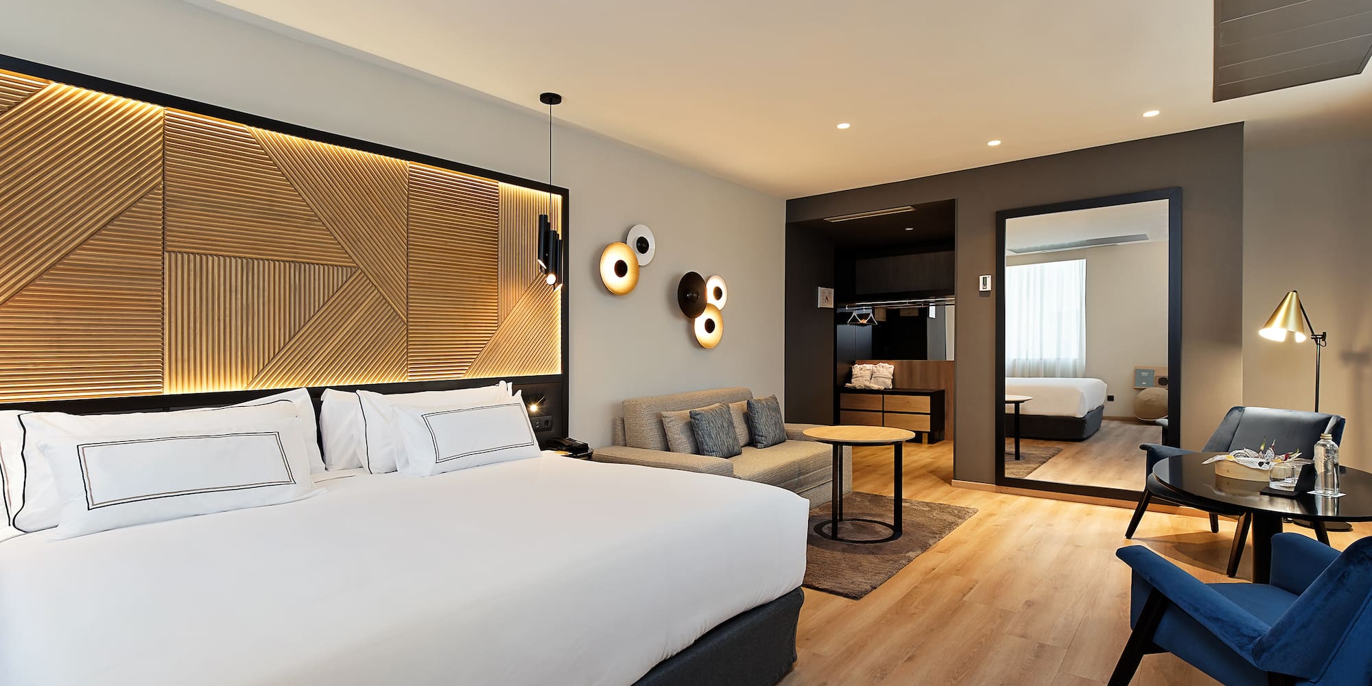 a room with a bed and a mirror