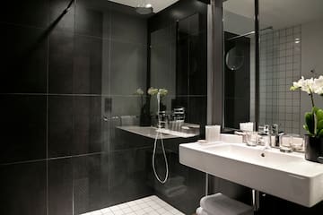 a bathroom with a shower and sink