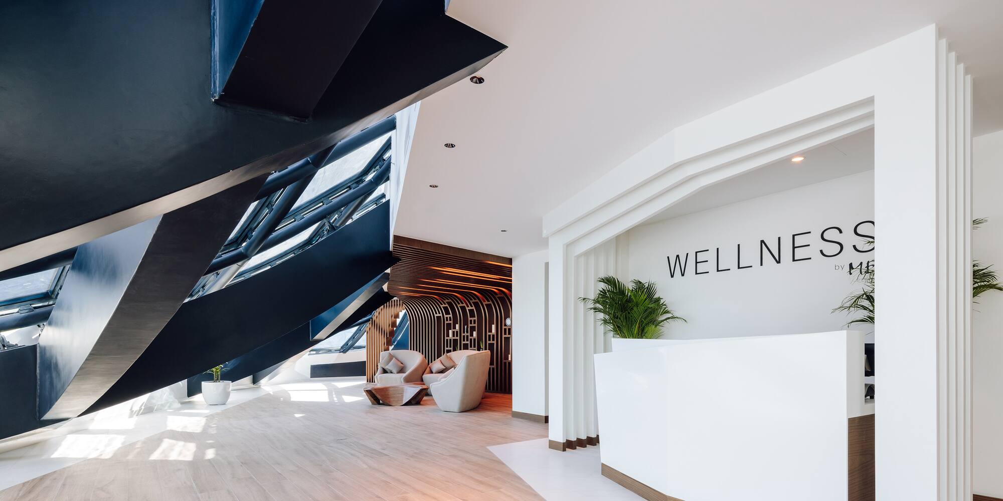 a lobby with a reception desk and a wood floor