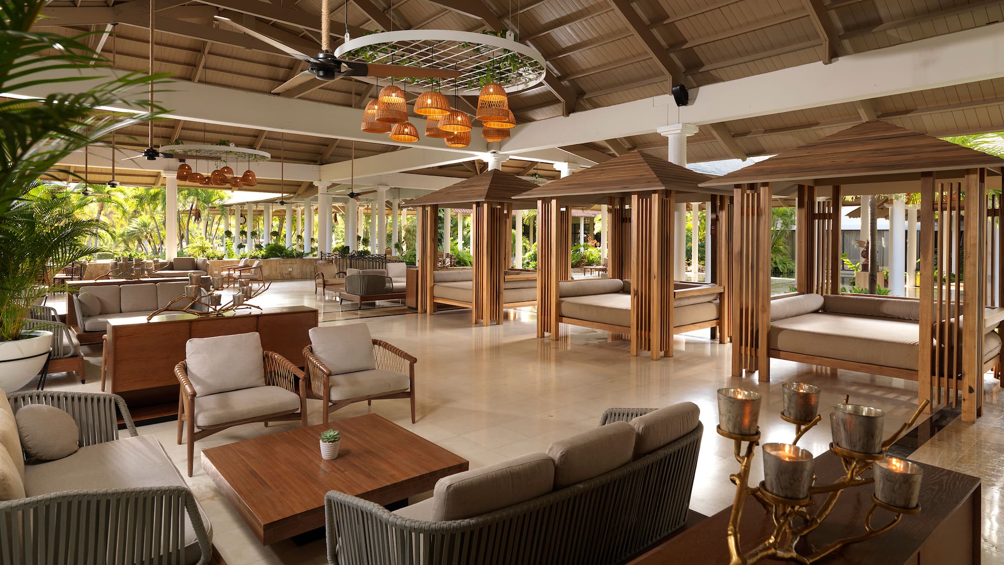 a room with a large area with furniture and tables