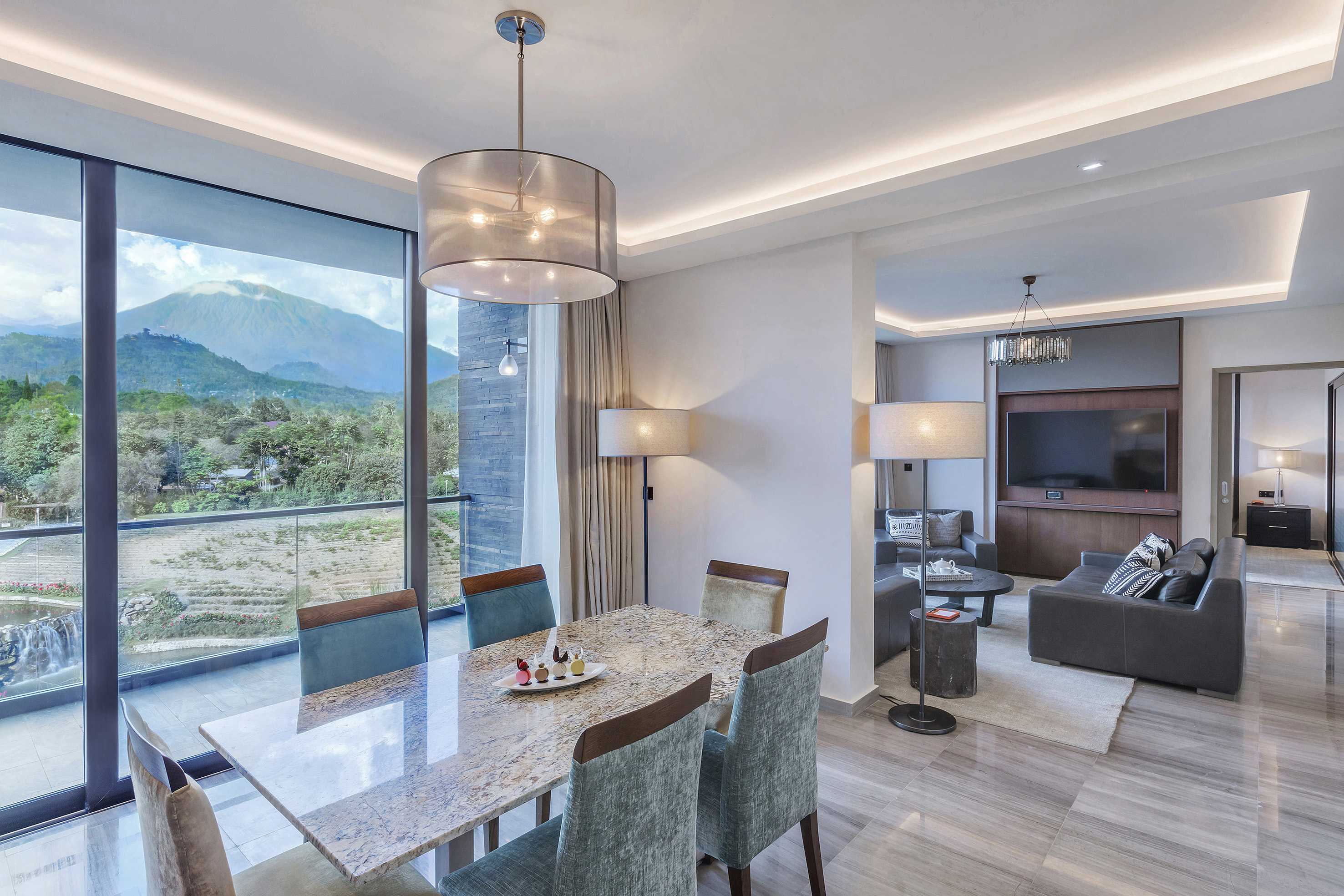 a dining table in a room with a television and a couch