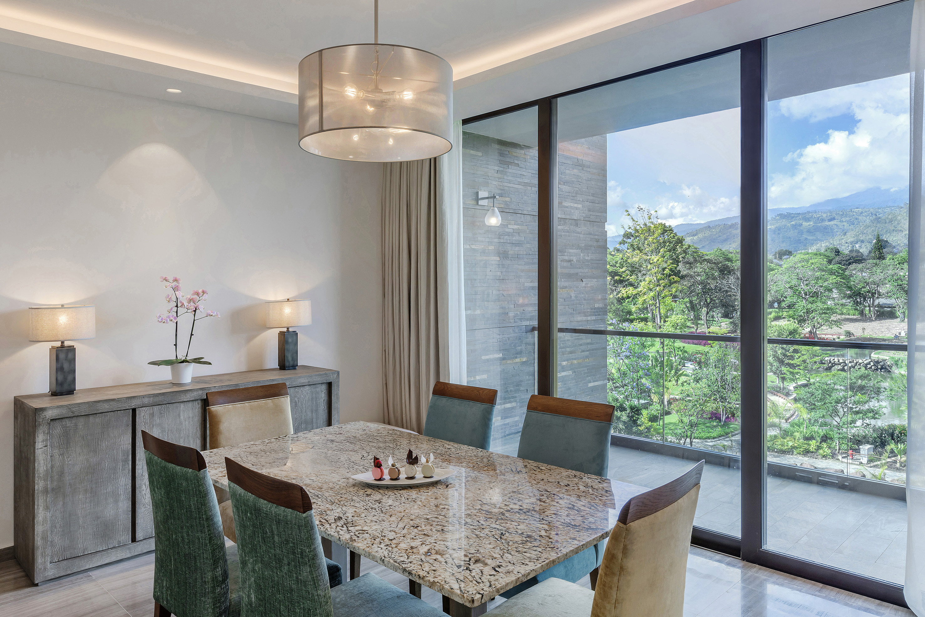 a dining table with chairs and a large glass door