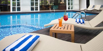 a pool with a drink and a table