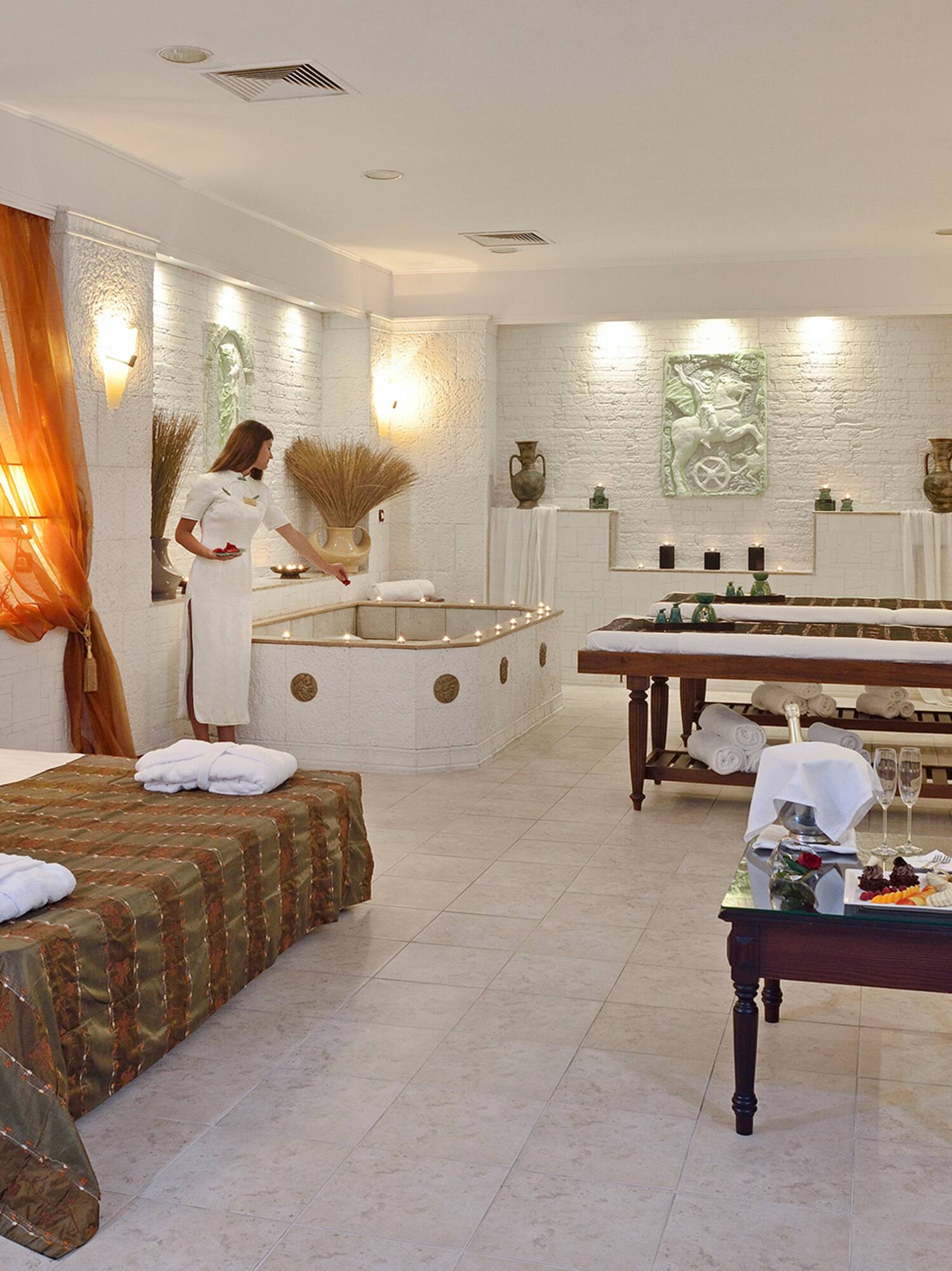 a room with a woman standing in front of a bathtub