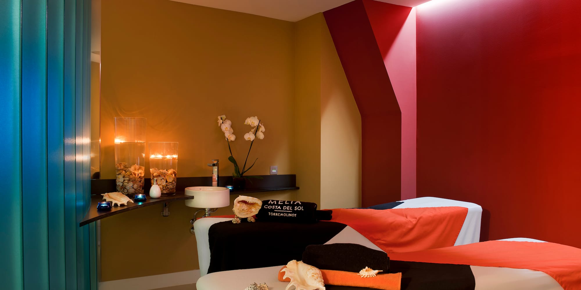 a massage room with a red and black towel