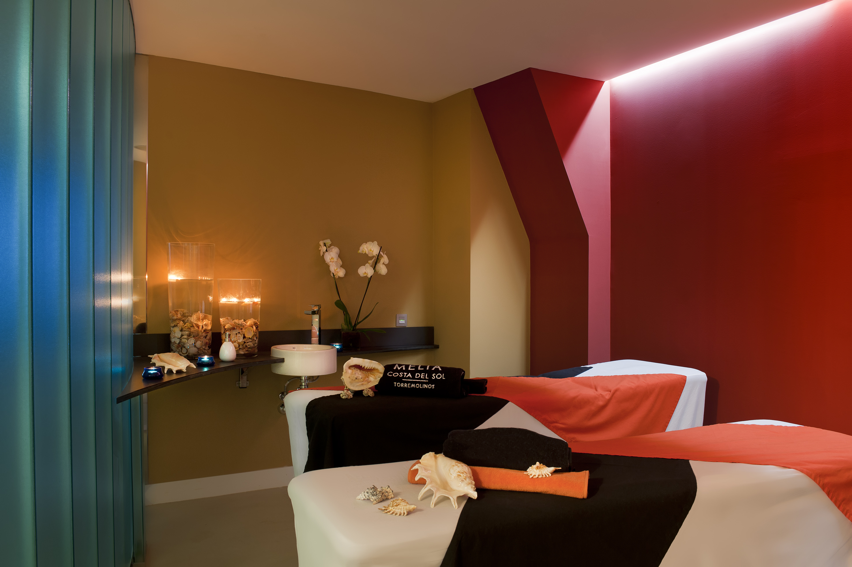 a massage room with a red and black towel
