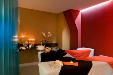 a massage room with a red and black towel