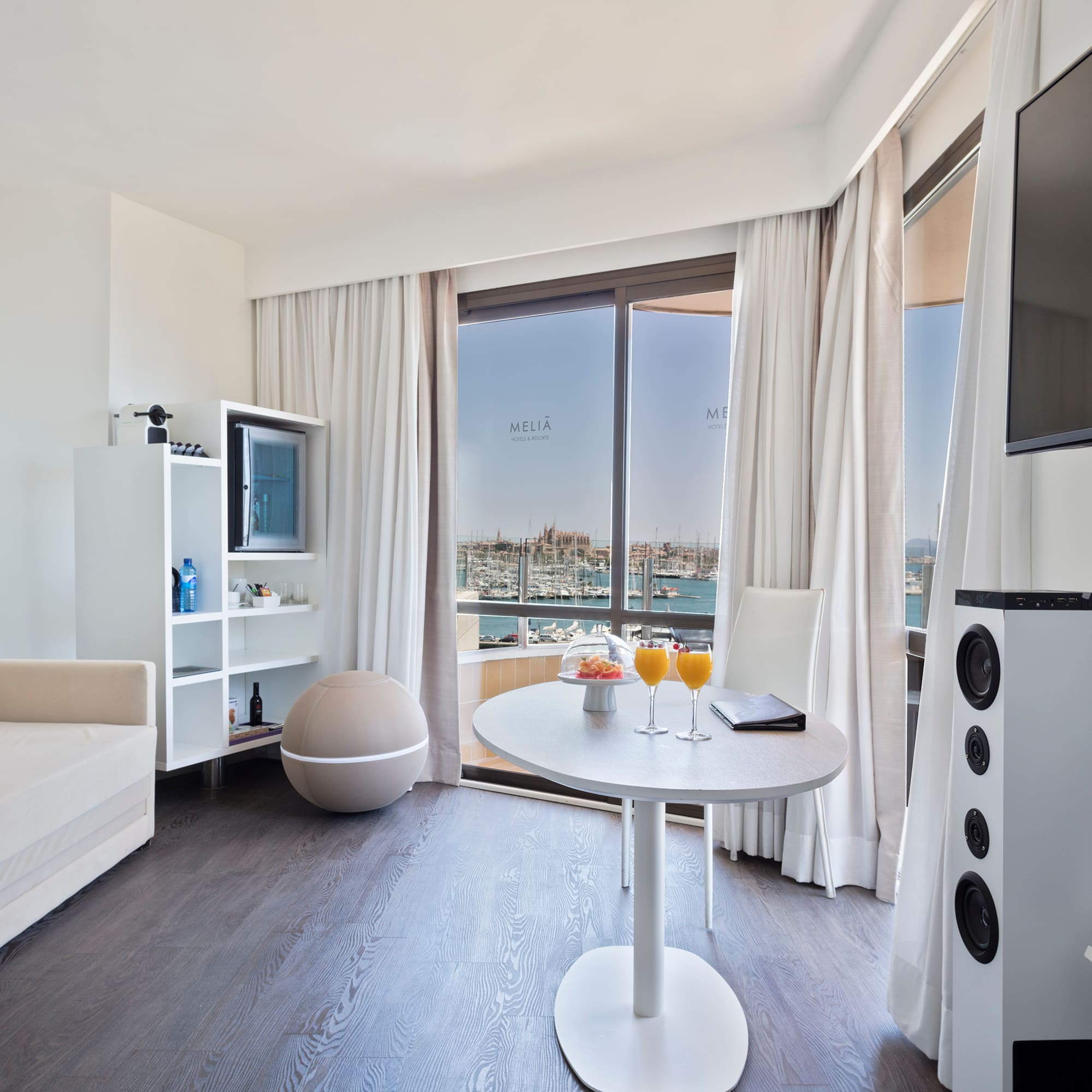 a room with a table and chairs and a television