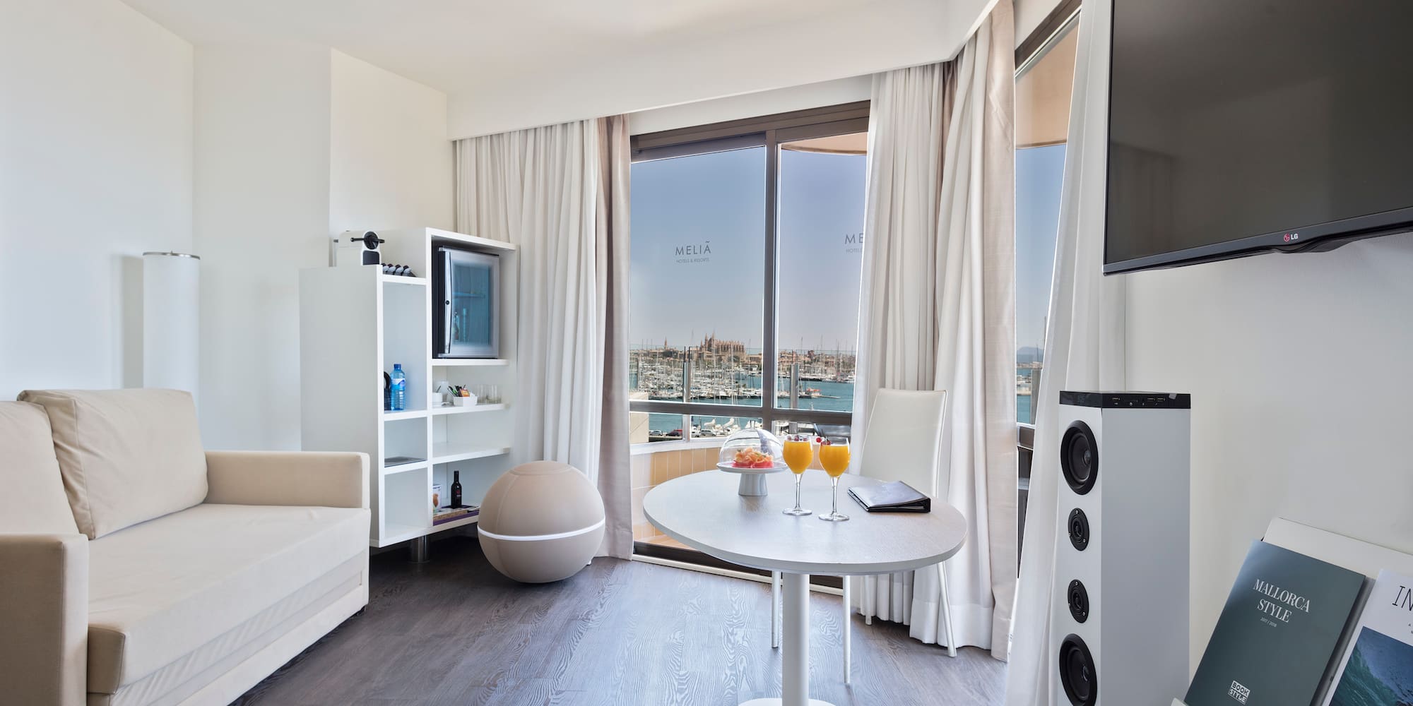 a room with a table and chairs and a television