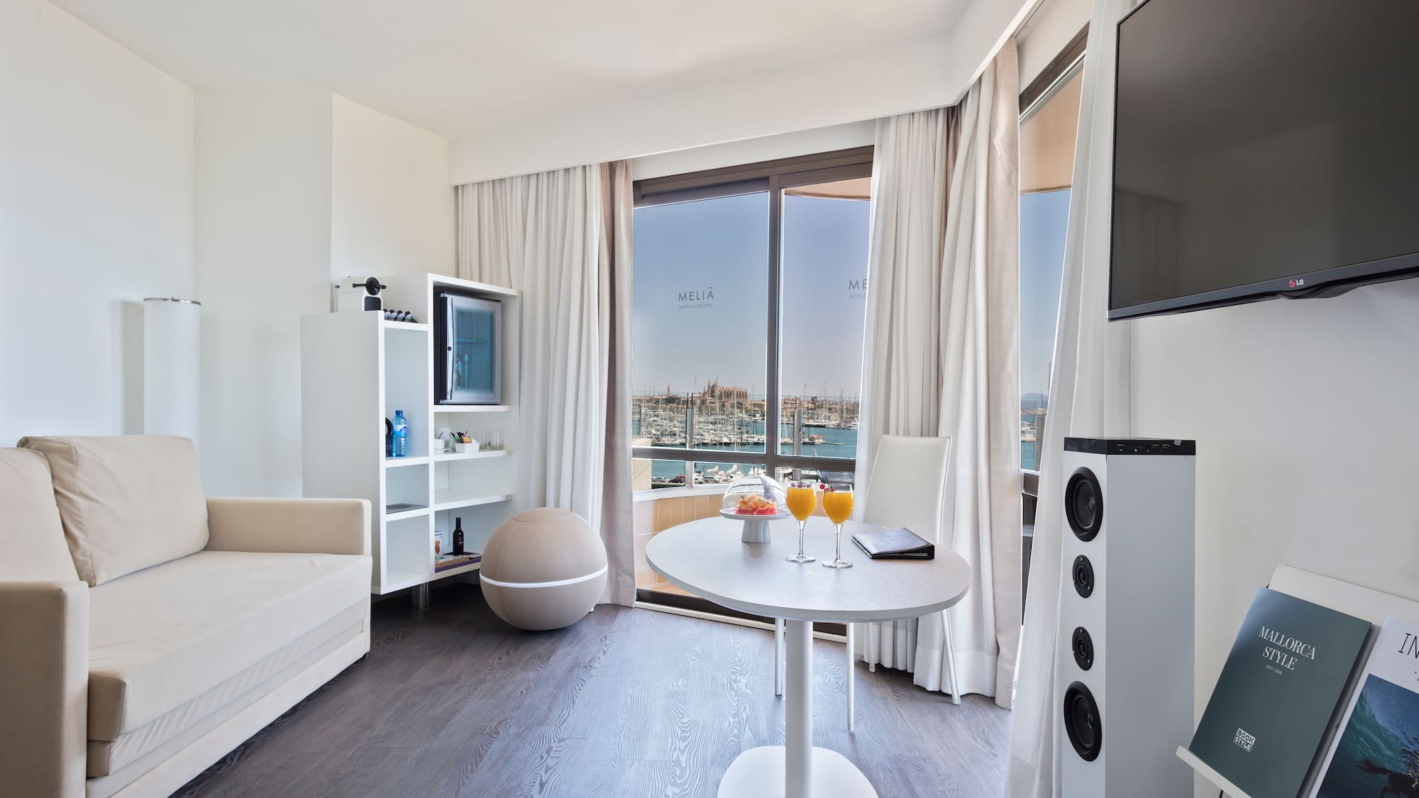 a room with a table and chairs and a television