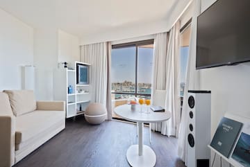 a room with a table and chairs and a television