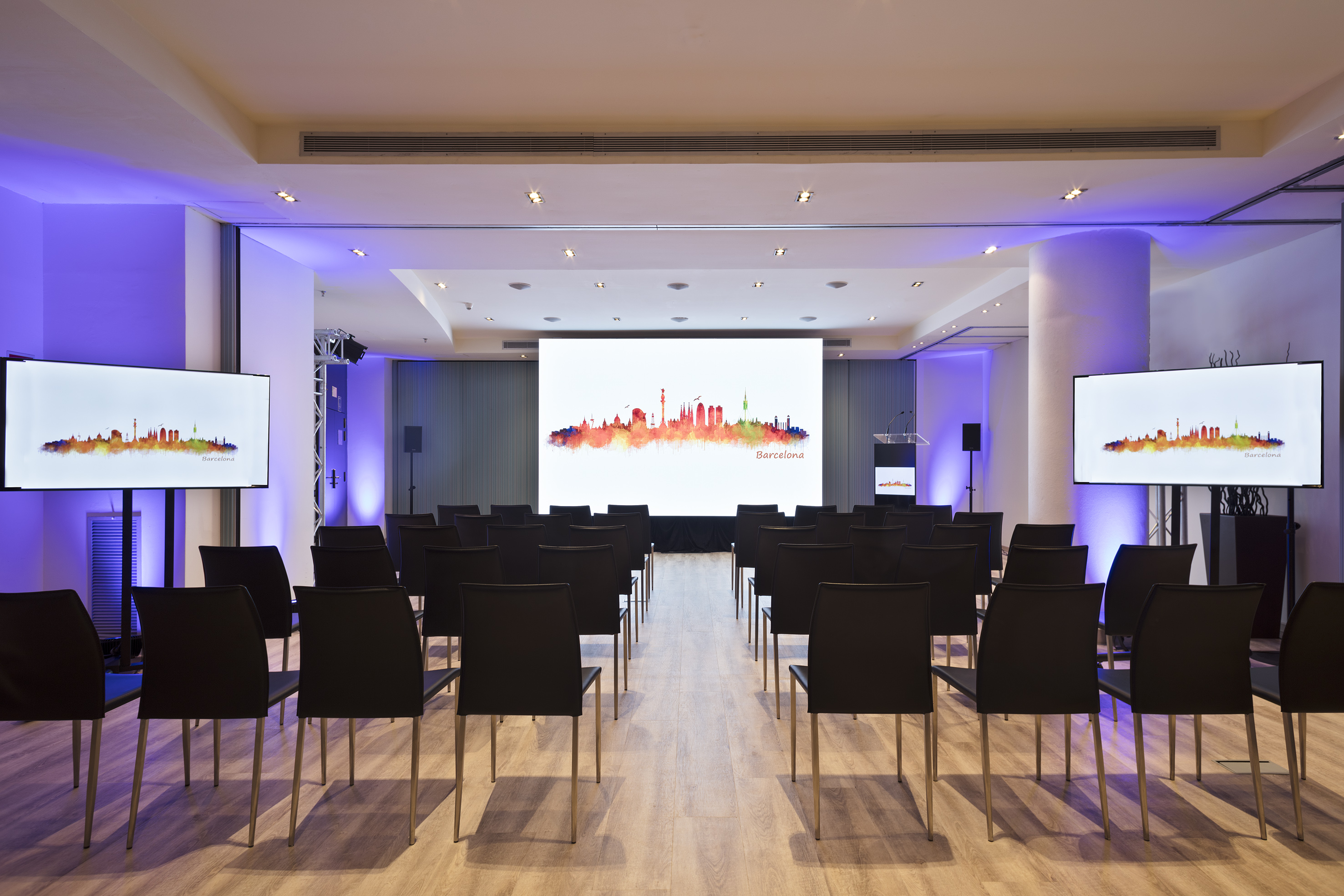 a room with chairs and a projector screen
