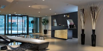 a lobby with a reception desk and a table