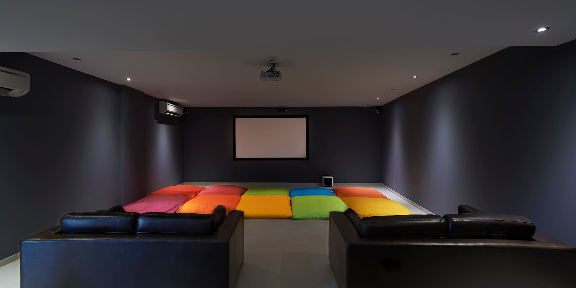 a room with couches and a projector