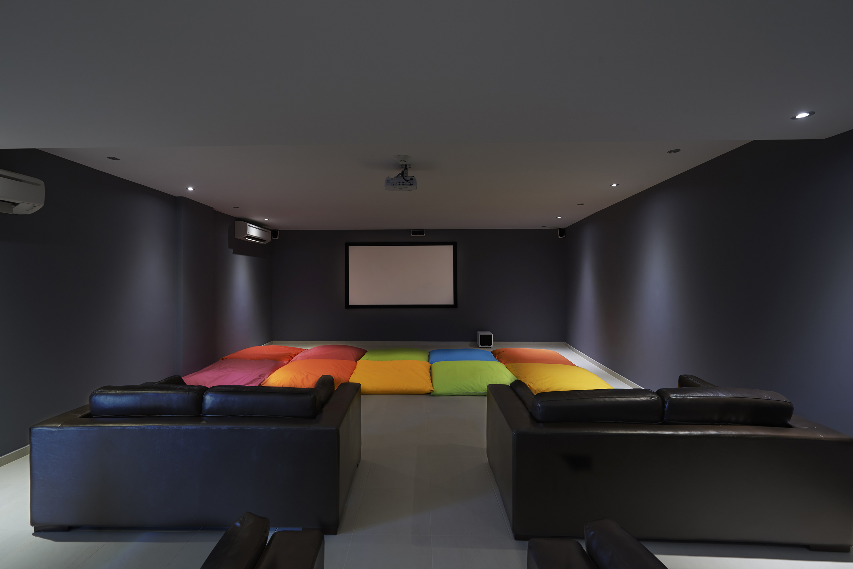 a room with couches and a projector
