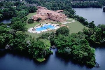 a large building surrounded by trees and water