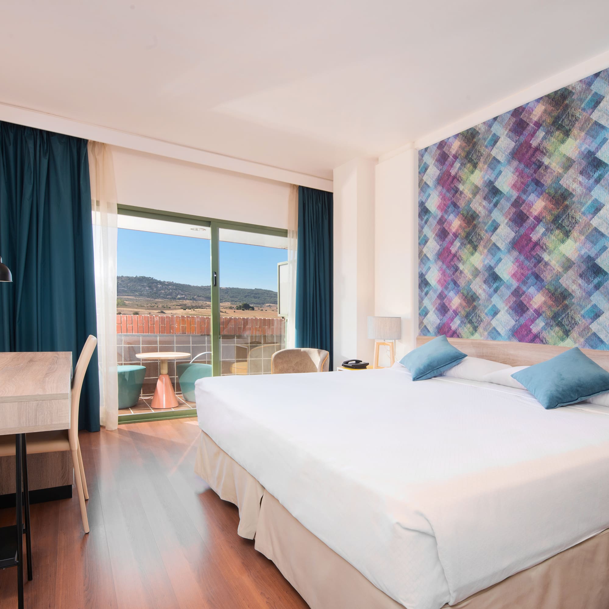 a room with a bed and a table and chairs