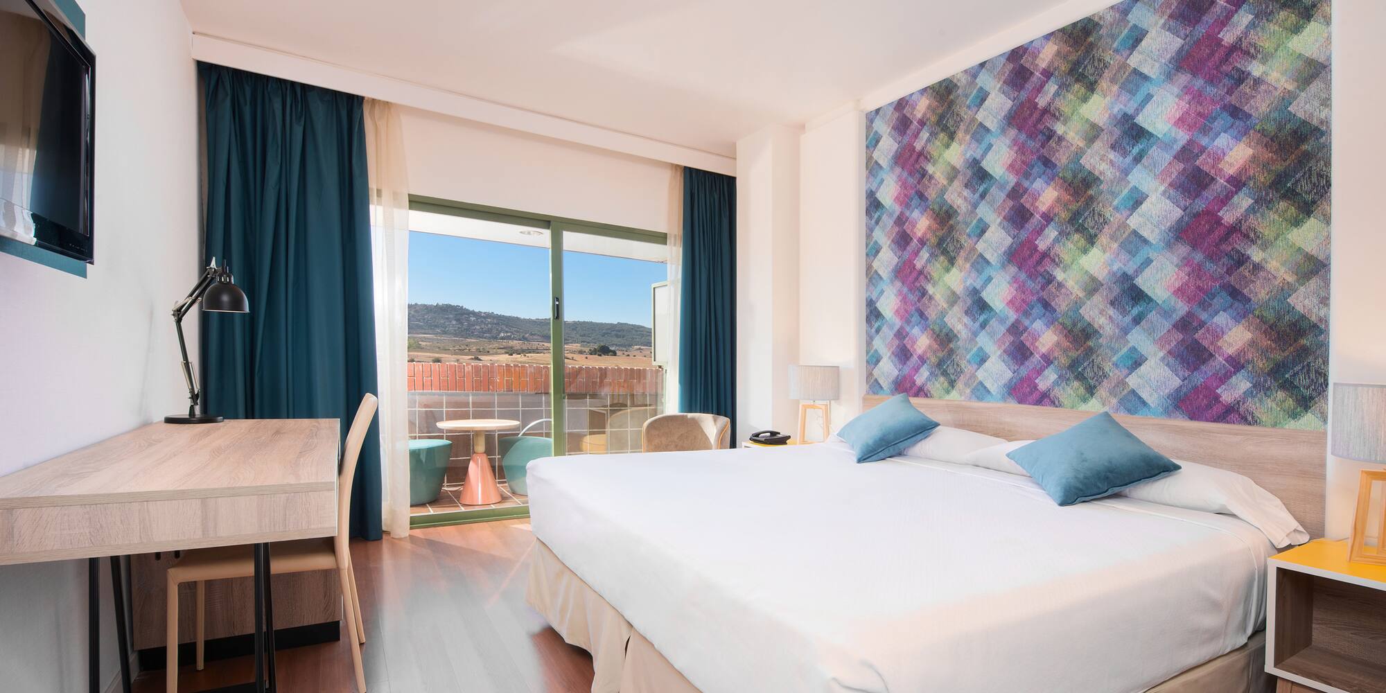 a room with a bed and a table and chairs