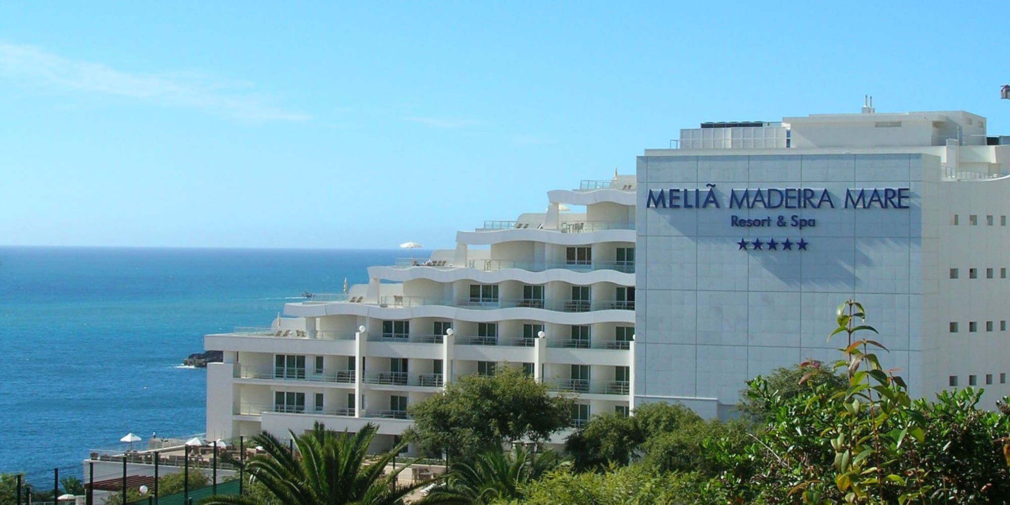 a white building next to the ocean