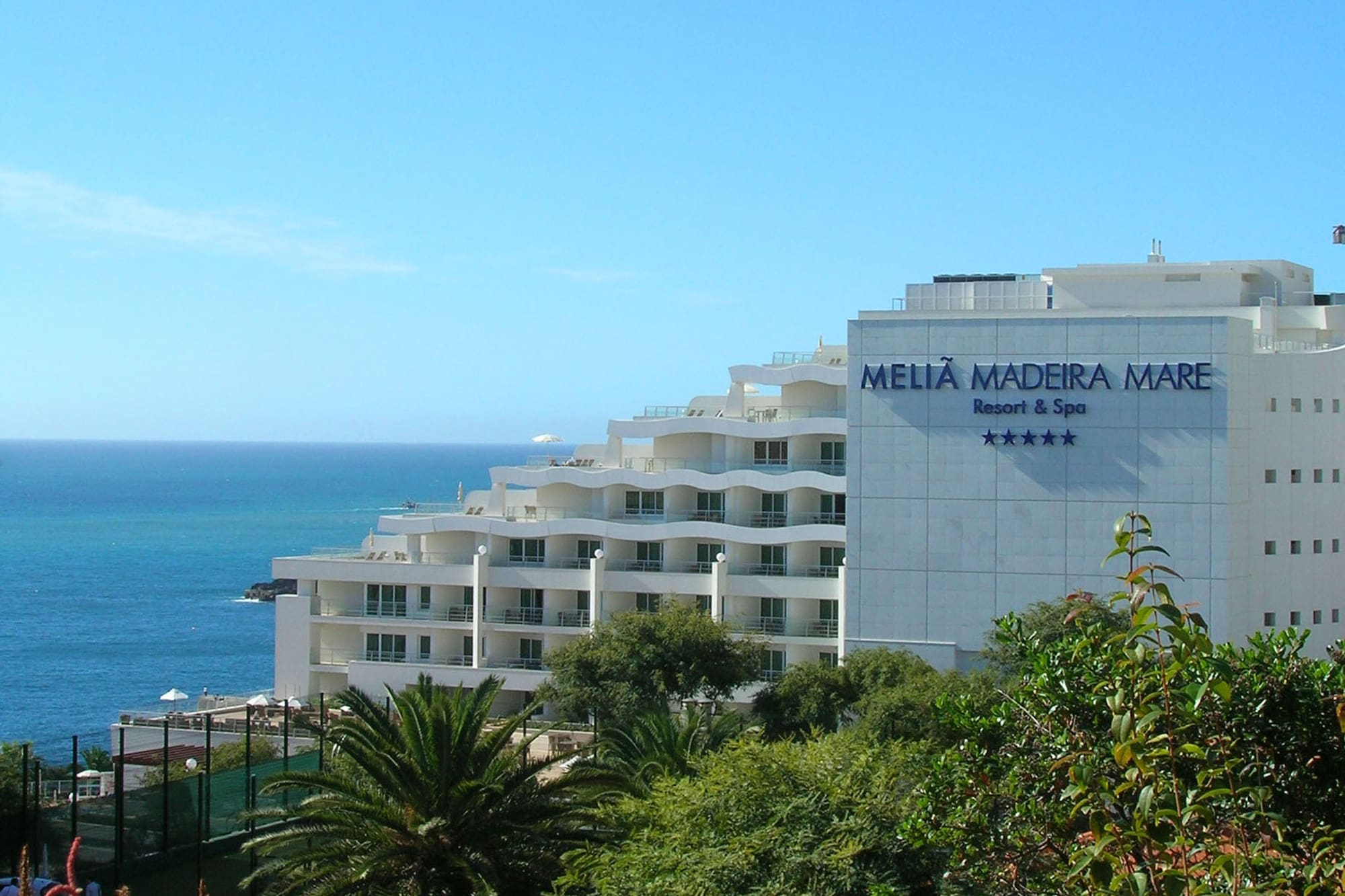Meliã Madeira Mare 5-star oceanfront resort and spa with lush plants.
