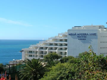 a white building next to the ocean