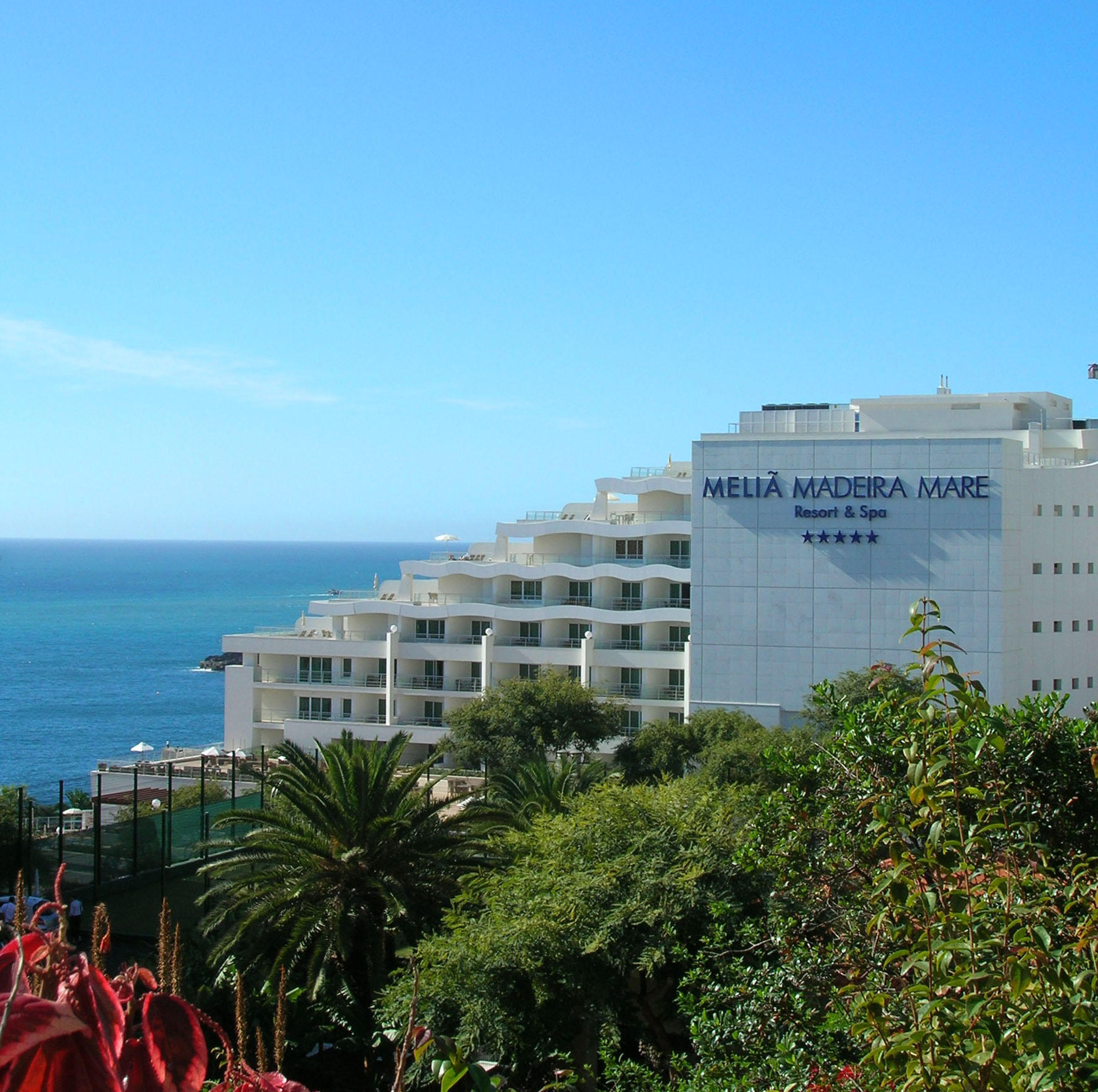 Meliã Madeira Mare 5-star oceanfront resort and spa with lush plants.