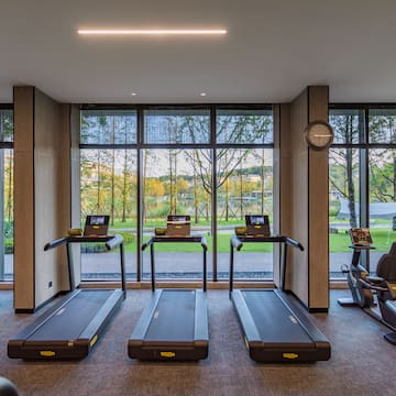 a room with treadmills and a clock