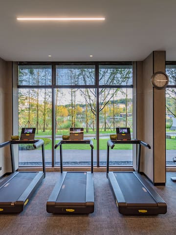 a room with treadmills and a clock