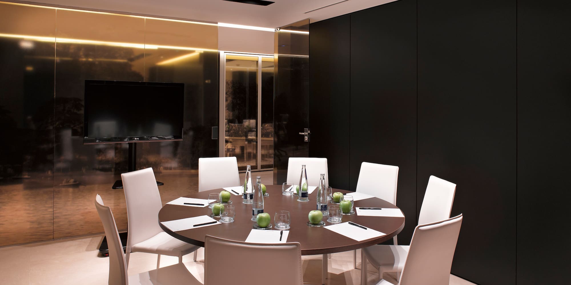 a room with a round table and chairs